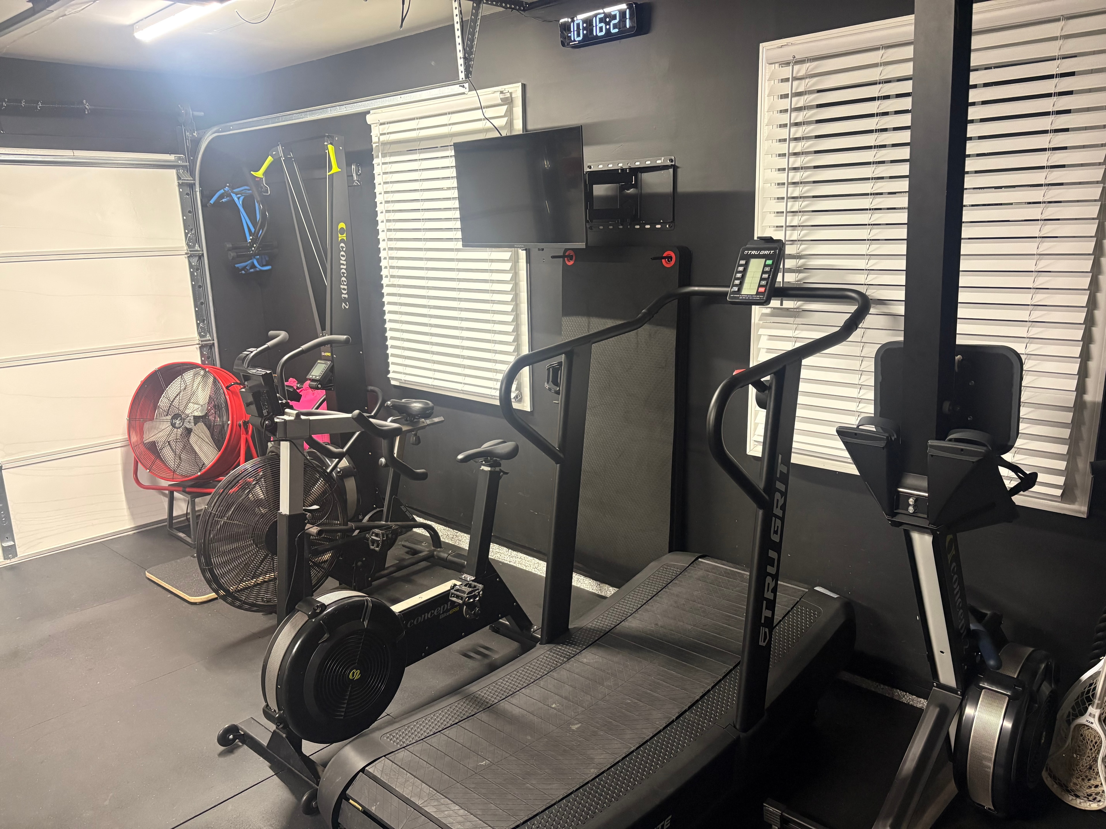Funeral Fitness cardio equipment — air bike, rower, curved treadmill